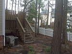 Fenced-in wooded backyard