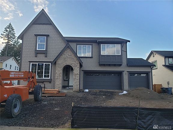 Inviting entry with warm hardwood flooring and elegant white painted open railing. Photo not of actual home - may contain optional features.