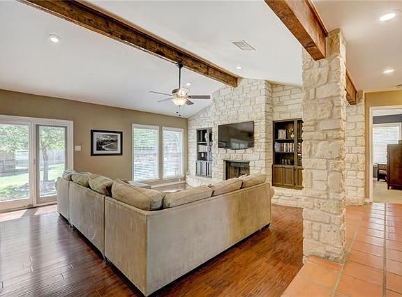 Double windows and french doors (updated for energy efficiency) let the sun shine in. Recent wood floors add to the warmth of the room.