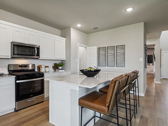 Kitchen in the Willow home plan by Trophy Signature Homes - REPRESENTATIVE PHOTO
