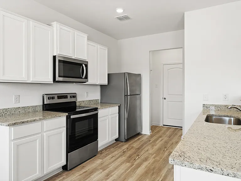Kitchen comes with stainless steel appliances.