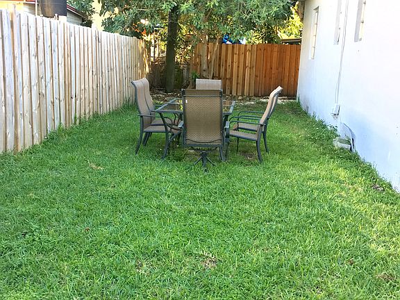 Shared backyard with table and seating for six.
