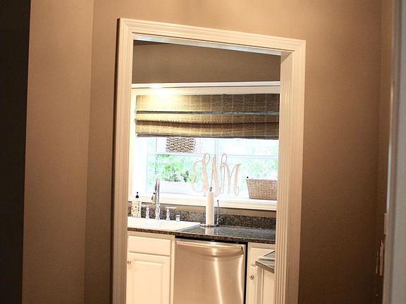 Entryway opens to kitchen and living room