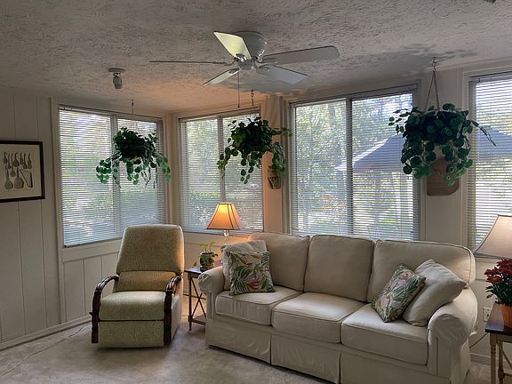 Sunroom overlooking private patio and golf course
