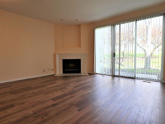 Large living room connected to kitchen, with wood fireplace
