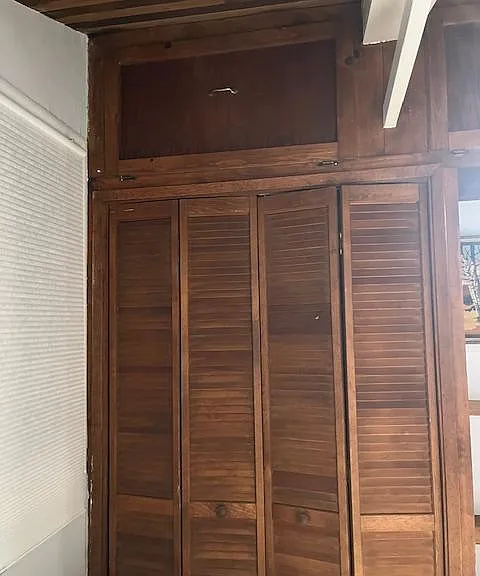 Closet and overhead cabinets in bedroom