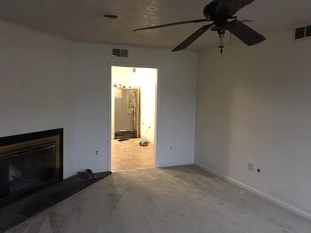 This is the living room. On the left, you can see the working fireplace.