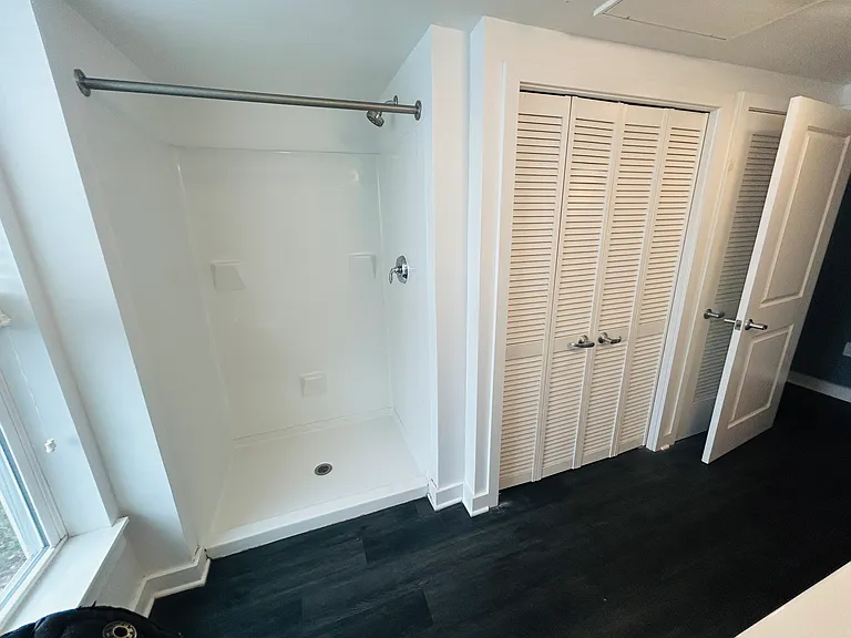 Large stand up shower - washer & dryer closet.