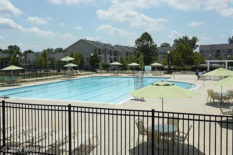 south village community swimming pool with tennis courts and play area.