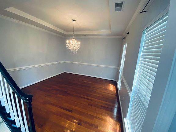 Formal Dining Room with elegant chandelier - wood floors.