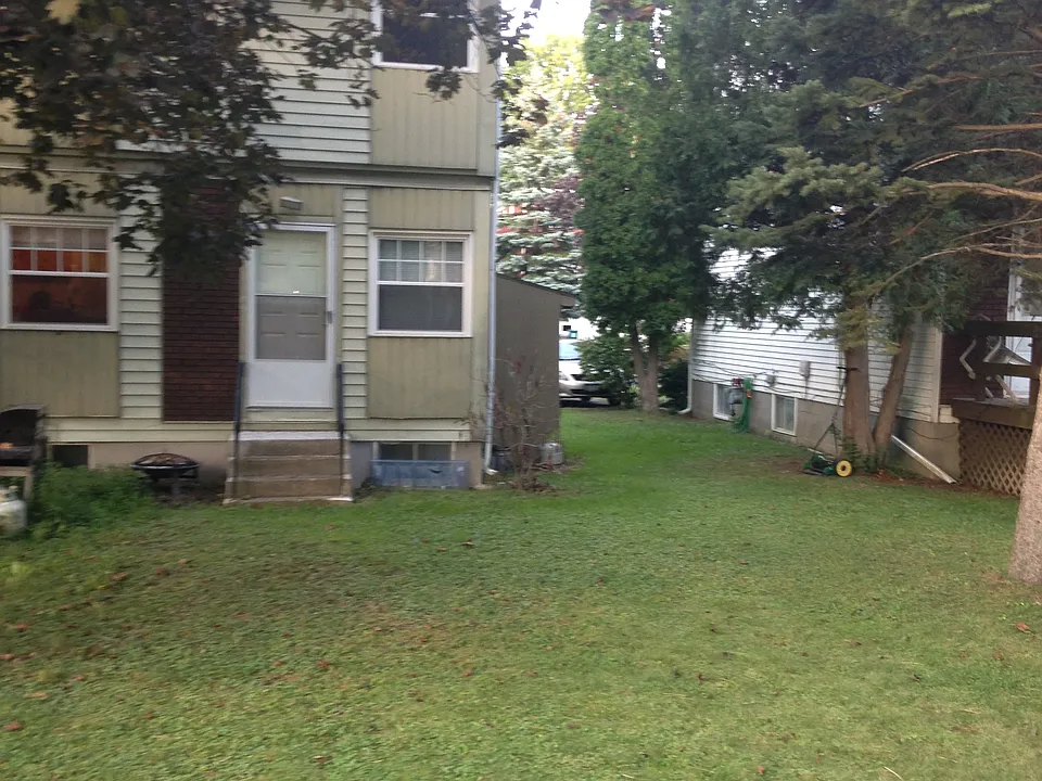 Neighboring yard - yours is same size to the left - you have use if lawn equipment in the shed