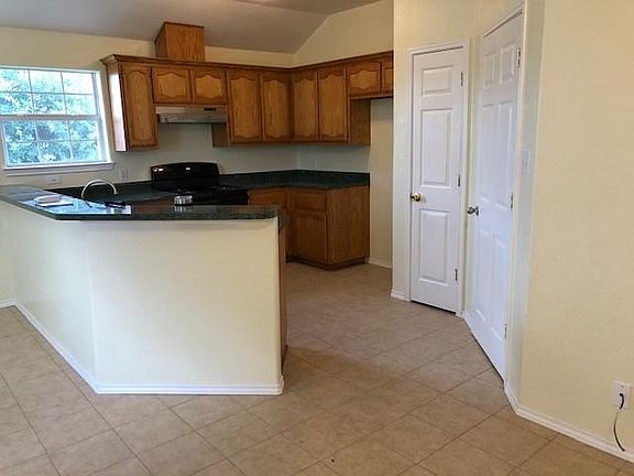 Kitchen with breakfast bar, pantry, and door to laundry and garage