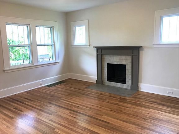 Large living room with new decorative fireplace and hand-built mantle.