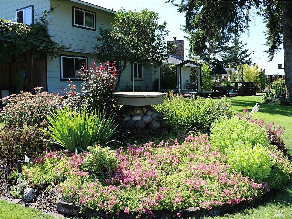 NE corner flower bed/lawns