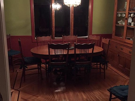 Dining Room area with custom hardwood flooring with doorway to kitchen, living room and garage enty