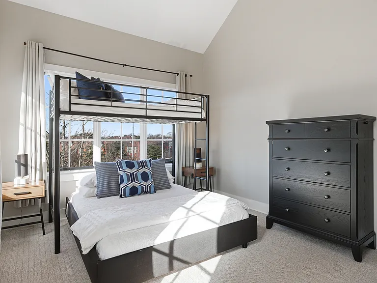 Bedroom 3 with a full over queen bunk bed, ensuite bathroom, and dresser for your belongings. Also includes a walk-in closet. Located on the 3rd floor.