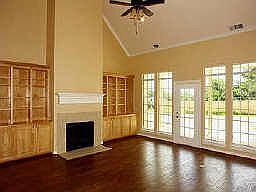 Stunning family room with built ins, wall of windows and wood floors.