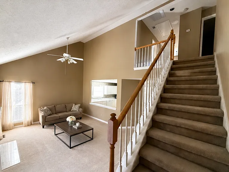 Living room, view of kitchen and stairs to second level
