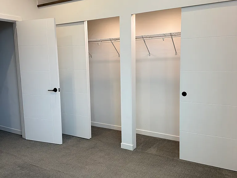 Huge lighted closet in master bedroom room.