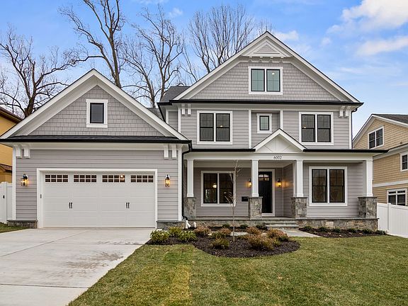 Shingle, stone, and covered porch - one cohesive form