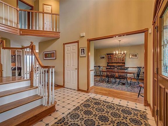CERAMIC TILE ENTRY, OPEN STAIRCASE, LEAD GLASS FRONT DOOR.