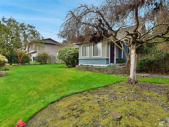 Welcome home! The tulips and daffodils are already poking out of the garden bed along the front of the home! 