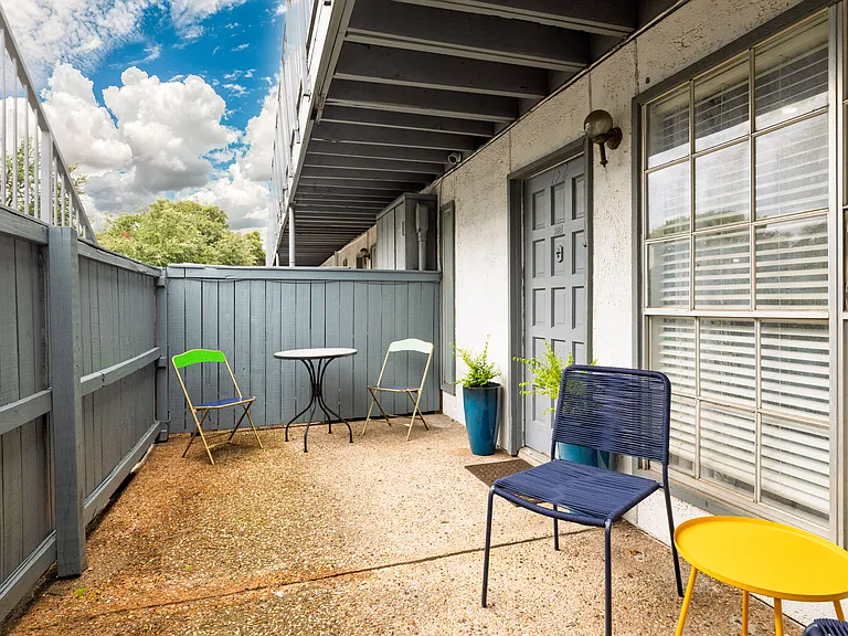 Step outside to a private patio with casual seating_an inviting spot to relax, get some fresh air, or enjoy a quiet moment outdoors.