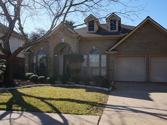 Mature lower maintenance landscaping in front yard.