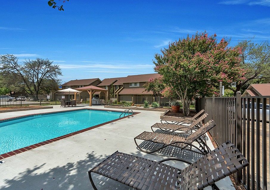 Sparkling community pool with sun deck and relaxing lounge chairs for residents