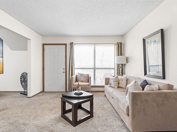 Open Living Room with Large Windows - Heritage Park Apartments