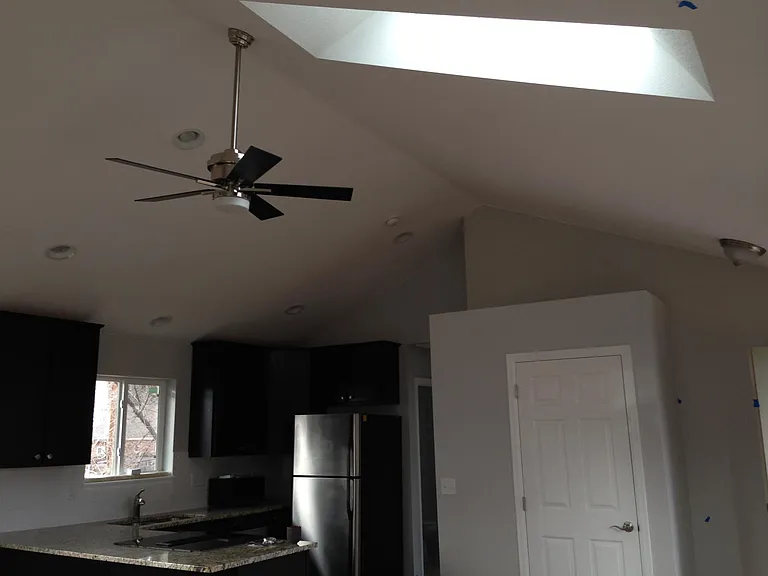 skylight, ceiling fan, vaulted ceiling