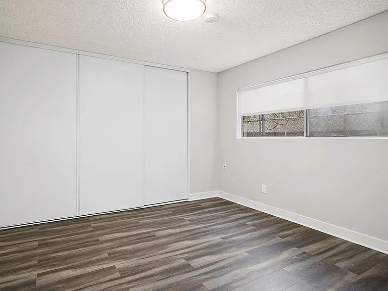 Hardwood floored bedroom with private closet.