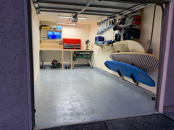 Newly painted and re-floored garage fits 1 car. Custom storage rack for boards, clubs and tools. Overhead storage above.