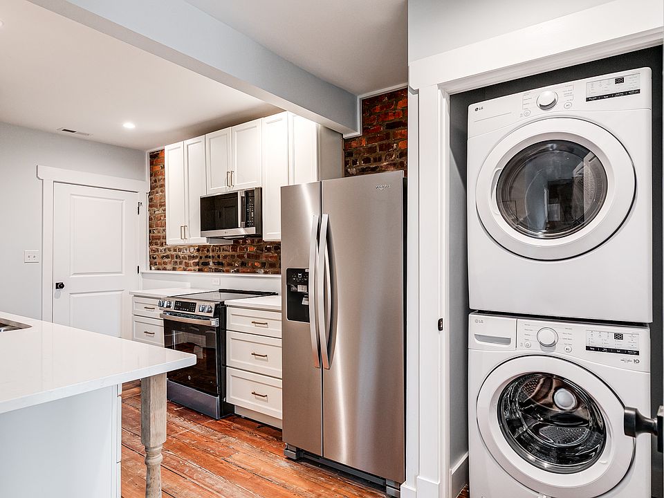 Exposed brick was left in this completely remodeled historic space. Convenient, energy-efficient washer and dryer in unit.