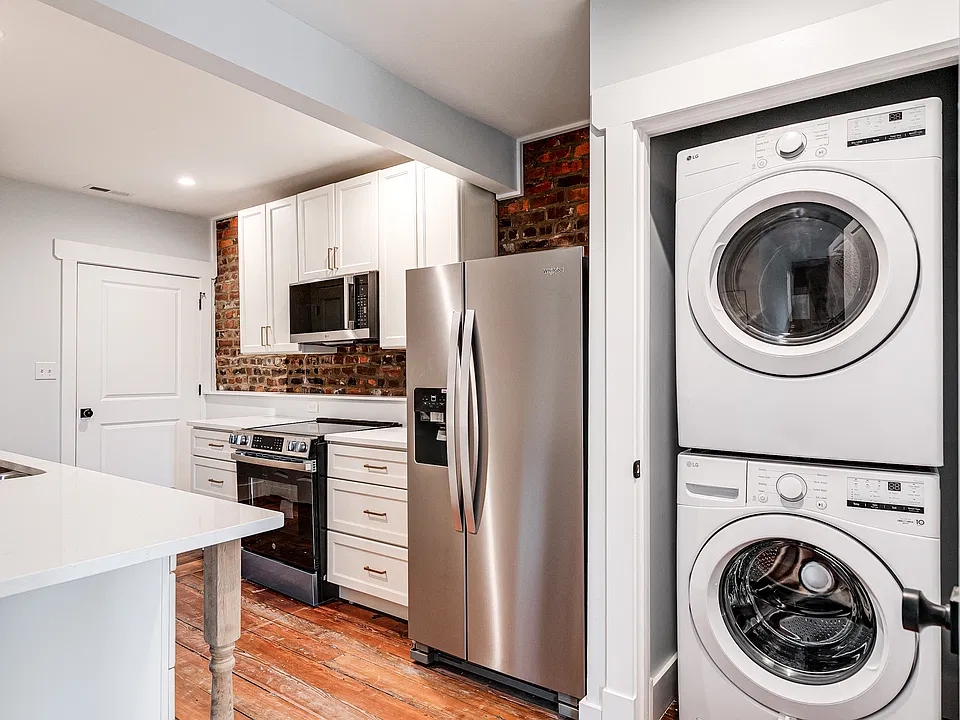 Exposed brick was left in this completely remodeled historic space. Convenient, energy-efficient washer and dryer in unit.