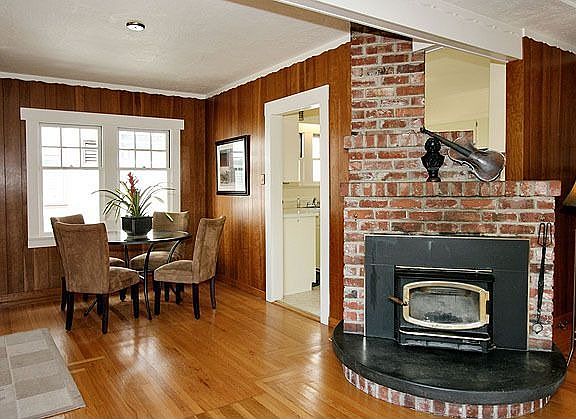 Light and airy dining area, and detailed view of wood stove and hearth