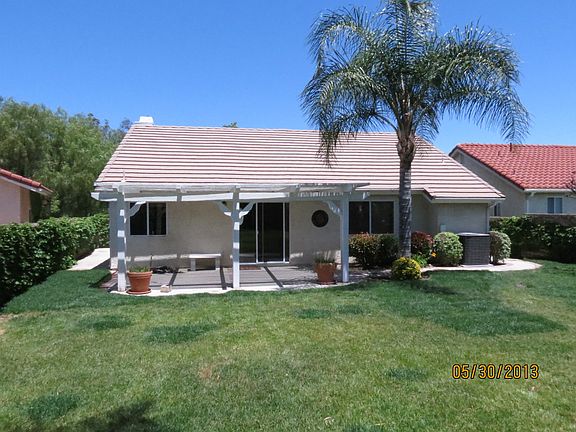 Patio with shade cover, palm tree