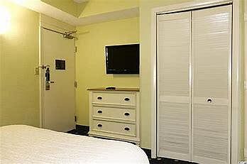 bedroom dresser, closet, flat screen TV with cable