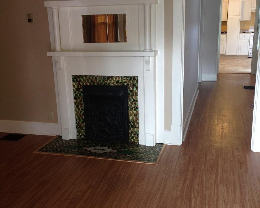 2nd photo of living room. Fireplace decorative only. Hallway leads to main level bedroom then into kitchen. Stairway is on left right before kitchen.