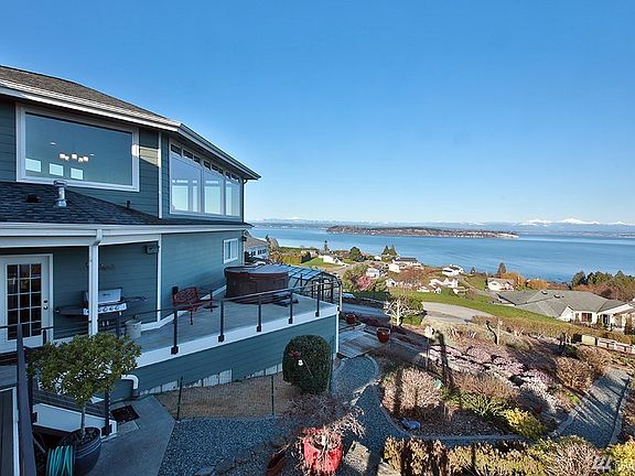 Views of Hat Island & Cascade Mountains. Look at your low maintenance yard equipped with drip/sprinkler system.  
