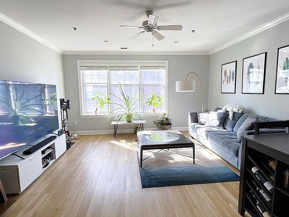 South-facing Living Room with Huge Windows and High Quality Blinds.