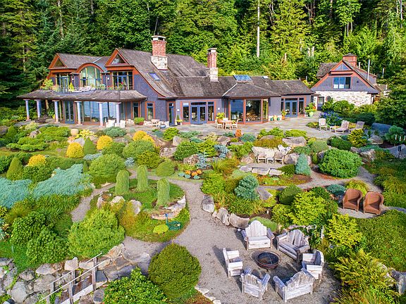 Shoreside, low maintenance gardens of dwarf conifers, succulents, drought tolerant native plants. Multiple patios shoreside.