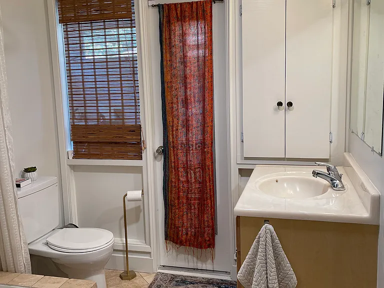 Primary bath with access to fully enclosed laundry room porch