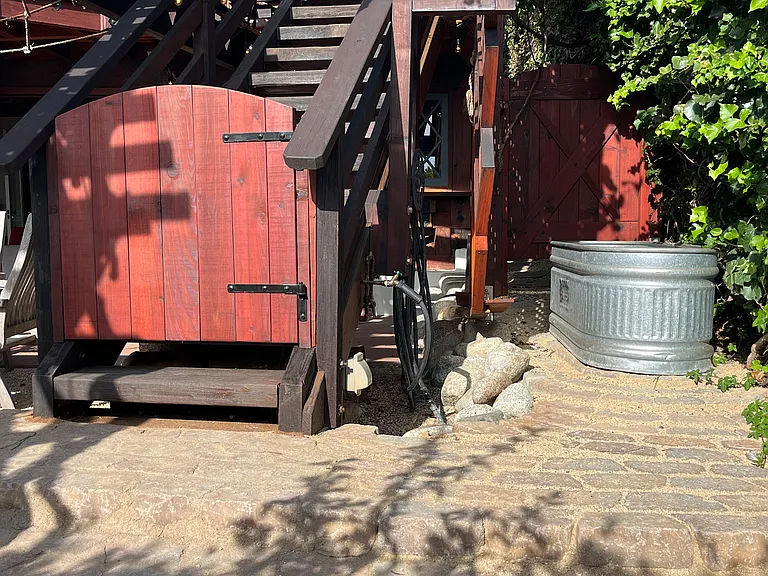 private gates separate bottom and top of exterior stairs, private outdoor hot and cold tub with paved patio stairsways