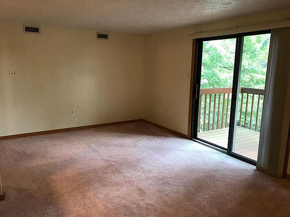 Living & dining area with sliding glass door leading to deck.