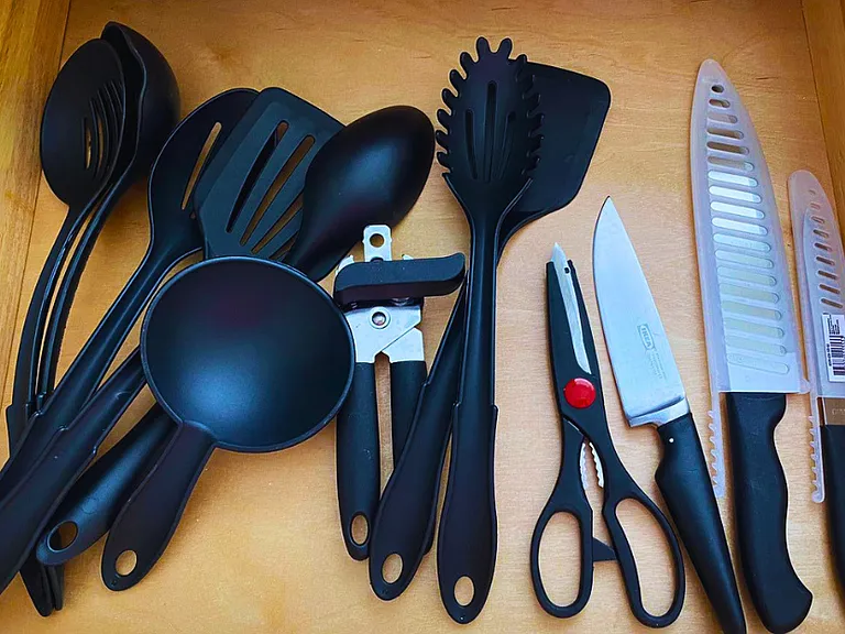 Large knives, ladles, and utensils for serving and frying food.