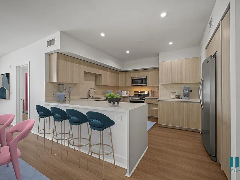 Kitchen with Countertop Bar, Stainless-Steel Appliances, and Ample Cabinet Storage