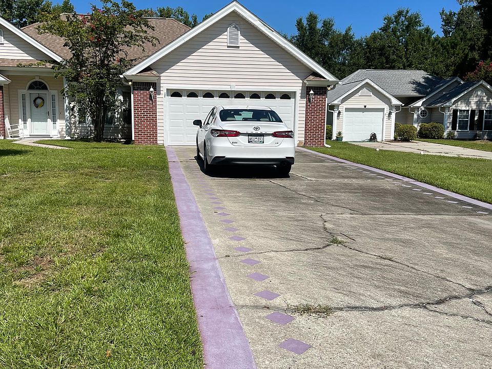 Spacious driveway leading to garage or front door