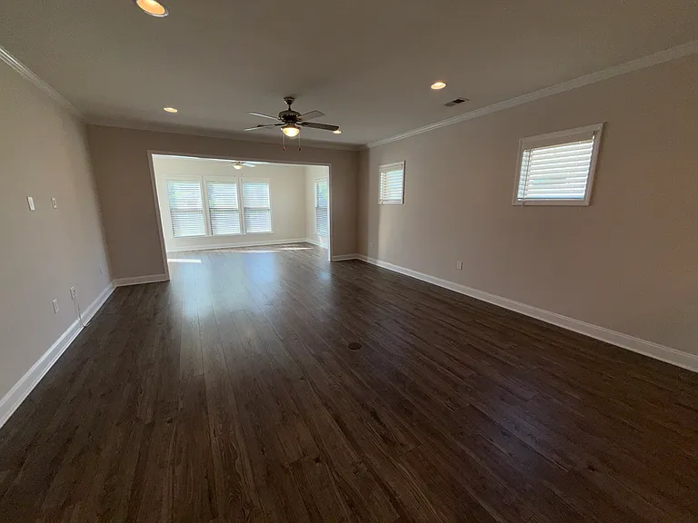 Living Room with 2 Windows, Ceiling Fan and 4 Recessed Lights. Floor Outlet and Prewire for TV on Wall