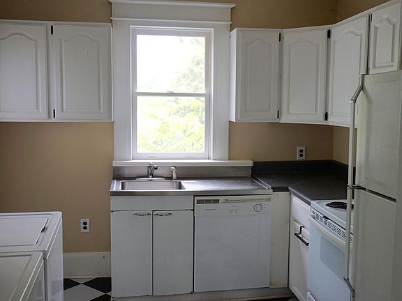 Kitchen with refrigerator, range, dishwasher, microwave, was
